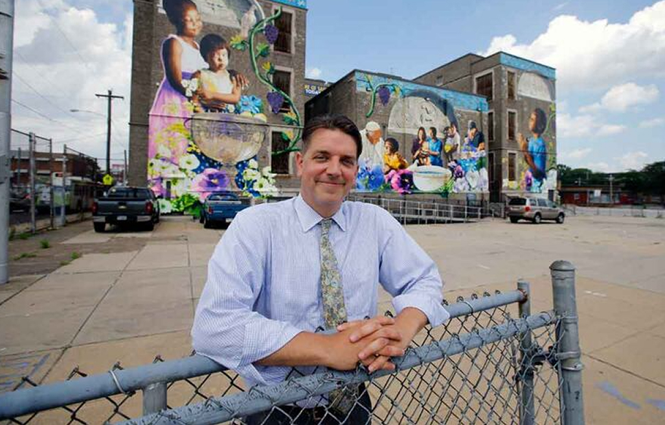 Man standing infront of St. Malachy's Building