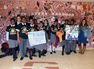 St Malachy Students & Faculty holding art posters